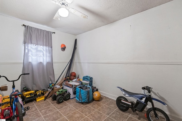 525 Firetower Rd, Williamston, SC 29697 - rec room featuring baseboards, tile patterned flooring, a textured ceiling, and a ceiling fan