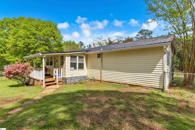 525 Firetower Rd, Williamston, SC 29697 - back of house featuring a yard, fence, metal roof, and a wooden deck