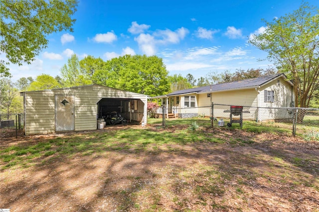 525 Firetower Rd, Williamston, SC 29697 - rear view of house featuring metal roof, fence, and an outdoor structure