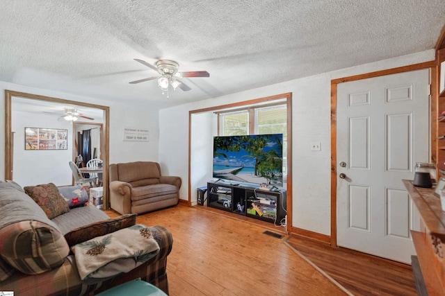 525 Firetower Rd, Williamston, SC 29697 - living room featuring baseboards, a textured ceiling, a ceiling fan, visible vents, and light wood finished floors