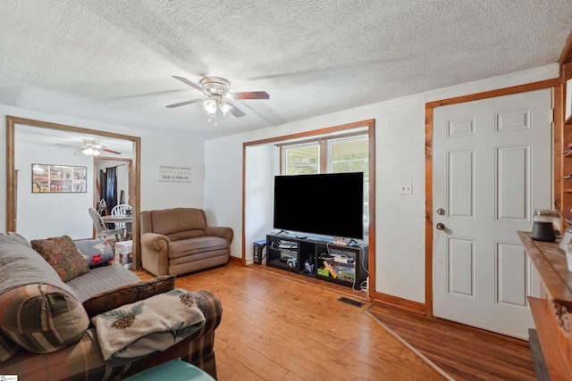 525 Firetower Rd, Williamston, SC 29697 - living area featuring light wood-type flooring, ceiling fan, baseboards, and a textured ceiling