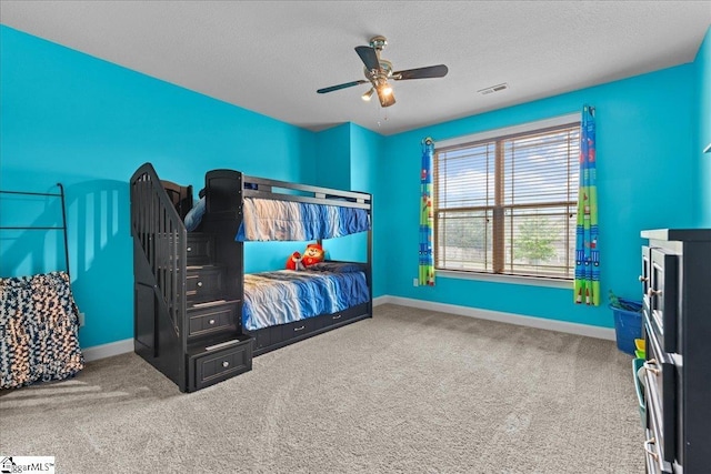 bedroom featuring a textured ceiling, baseboards, carpet, and visible vents