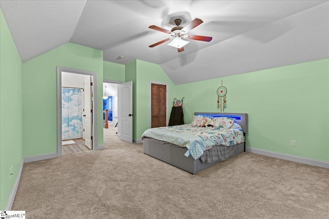 bedroom featuring a closet, carpet flooring, baseboards, and vaulted ceiling