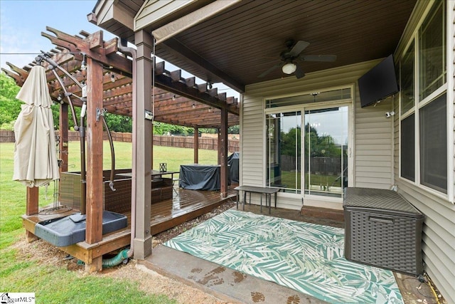 view of patio / terrace with fence, a wooden deck, and a ceiling fan