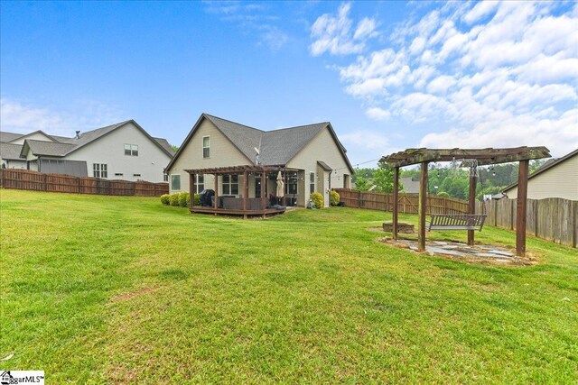 view of yard featuring a pergola, a fenced backyard, and a wooden deck
