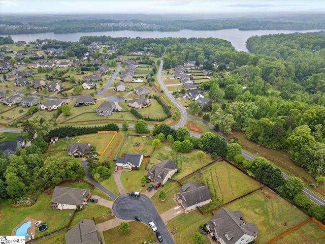 aerial view with a forest view and a water view