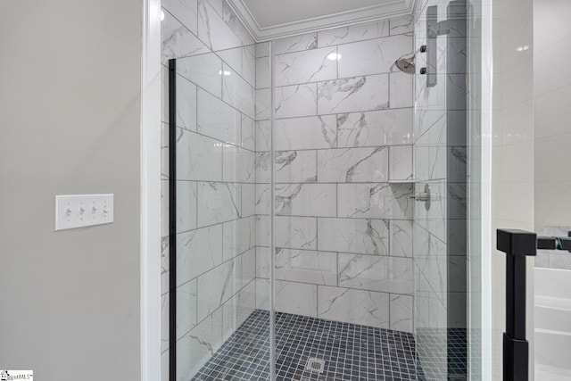 full bathroom featuring crown molding and a shower stall