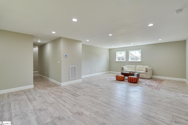 unfurnished room featuring light wood-type flooring, baseboards, visible vents, and recessed lighting