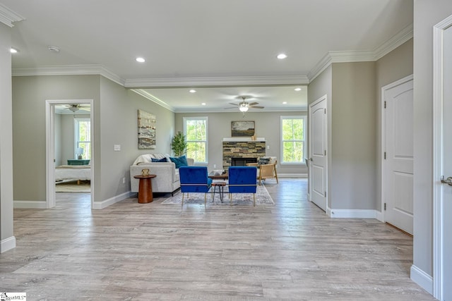 living room featuring light wood-style flooring, ceiling fan, recessed lighting, and a fireplace
