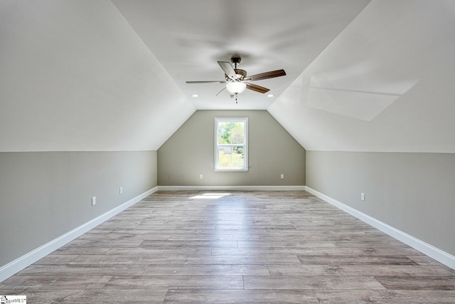bonus room with ceiling fan, baseboards, wood finished floors, and lofted ceiling