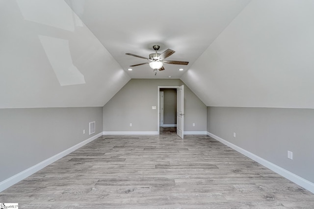additional living space featuring visible vents, baseboards, a ceiling fan, and lofted ceiling