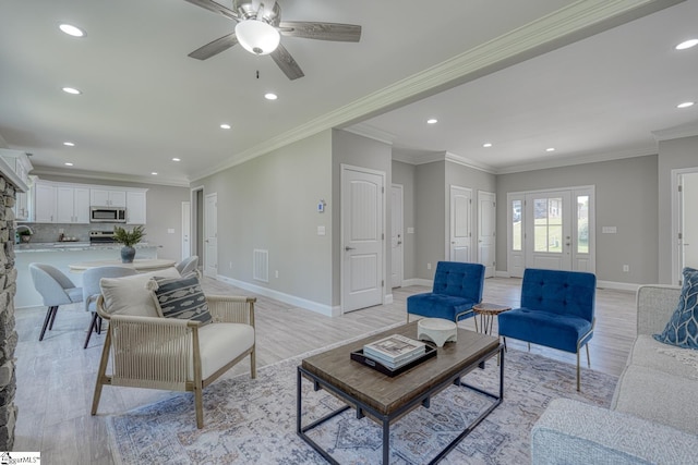 living room featuring visible vents, baseboards, light wood finished floors, and recessed lighting