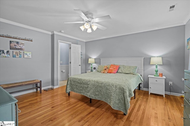 bedroom featuring ornamental molding, visible vents, light wood-style flooring, and baseboards