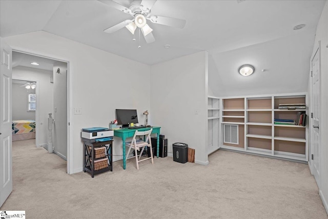 carpeted office space with visible vents, ceiling fan, vaulted ceiling, and baseboards
