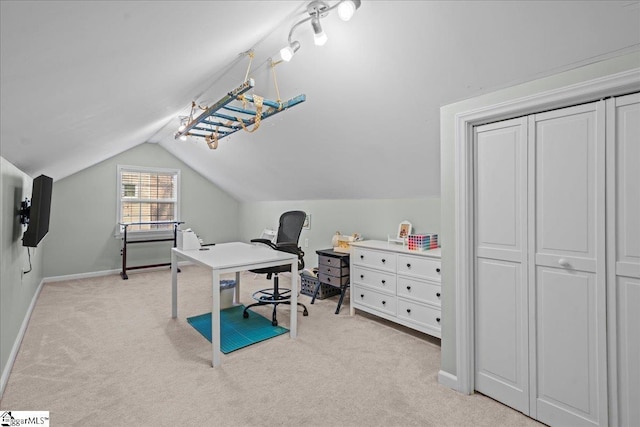 office area with baseboards, light carpet, and lofted ceiling