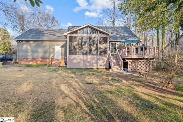 back of house with a sunroom, a lawn, a wooden deck, and stairs