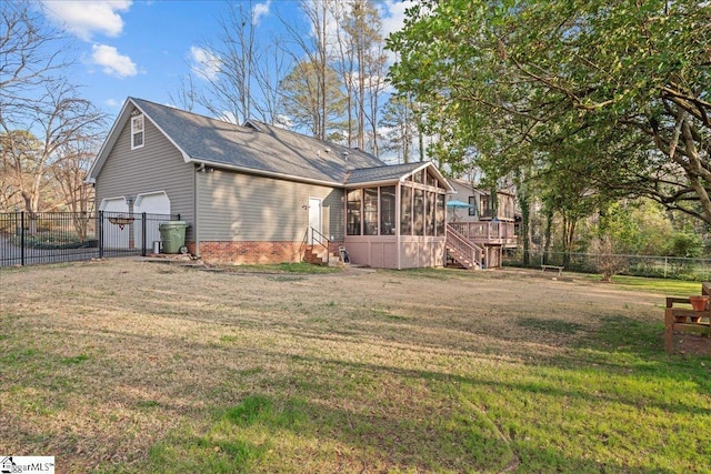 rear view of property featuring stairway, a fenced backyard, a garage, a yard, and a sunroom