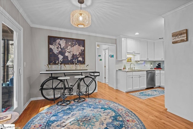 kitchen with a sink, light countertops, white cabinetry, and dishwasher