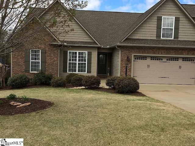 670 Secretariat Dr, Boiling Springs, SC 29316 - view of front of property with concrete driveway, a front lawn, brick siding, a garage, and a shingled roof