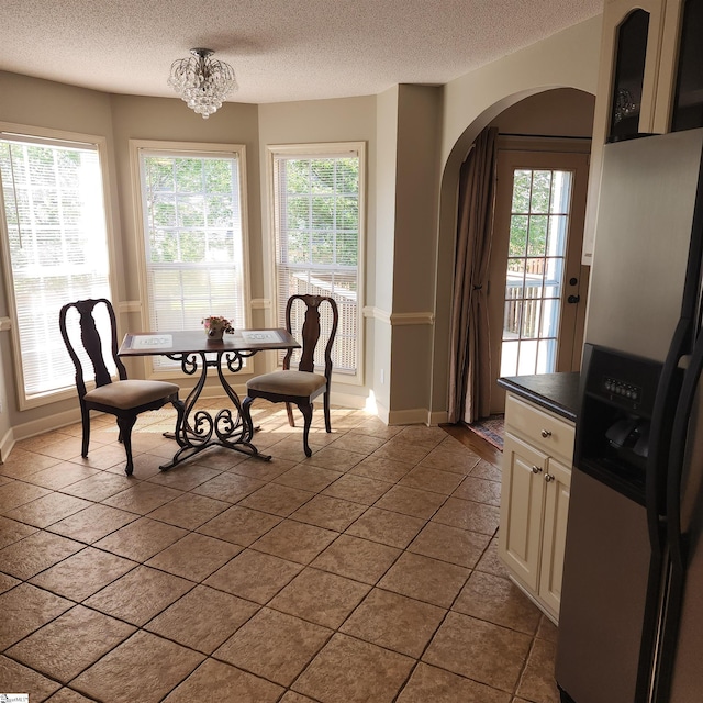 670 Secretariat Dr, Boiling Springs, SC 29316 - dining room featuring a wealth of natural light, arched walkways, a textured ceiling, and baseboards