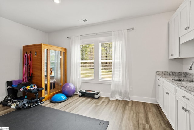 901 Whitemarsh Ave, Simpsonville, SC 29680 - workout area with visible vents, baseboards, a sink, and wood finished floors