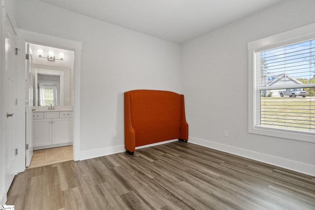 901 Whitemarsh Ave, Simpsonville, SC 29680 - spare room with wood finished floors, a sink, and baseboards