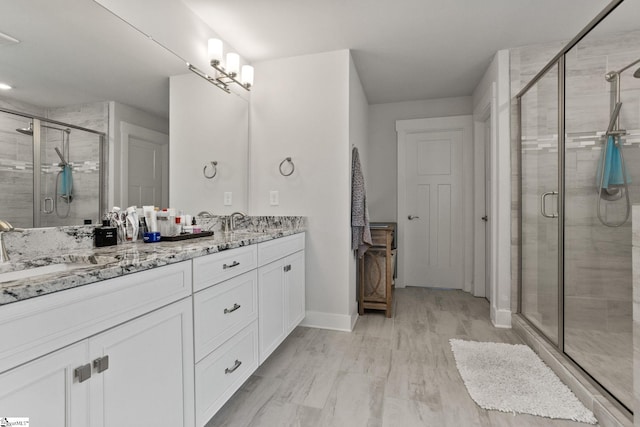 901 Whitemarsh Ave, Simpsonville, SC 29680 - bathroom featuring a shower stall, double vanity, baseboards, and a sink