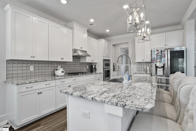 901 Whitemarsh Ave, Simpsonville, SC 29680 - kitchen with white cabinets, an inviting chandelier, a sink, under cabinet range hood, and stainless steel appliances