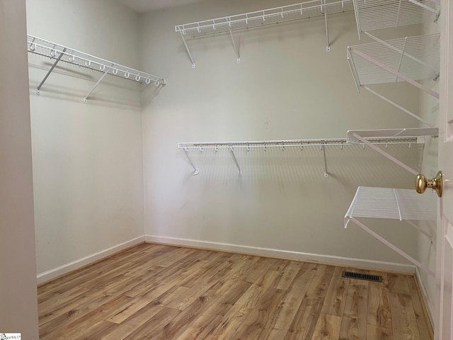 walk in closet featuring wood finished floors and visible vents