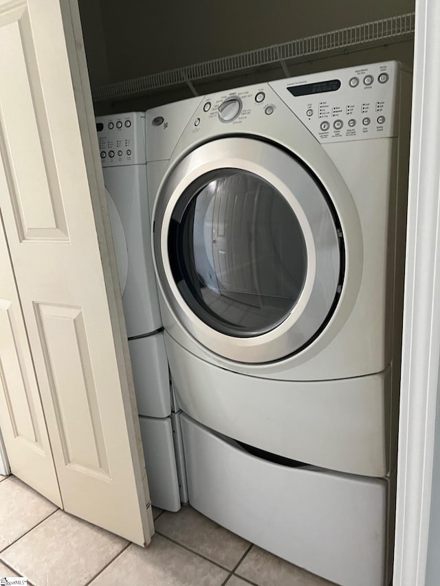 laundry room with laundry area and light tile patterned floors