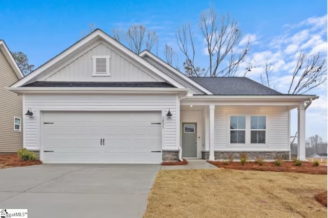 1031 Whitefox Dr Lot 53, Spartanburg, SC 29307 - view of front of home with board and batten siding, concrete driveway, a garage, and stone siding