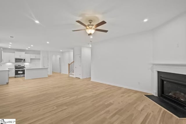 1031 Whitefox Dr Lot 53, Spartanburg, SC 29307 - unfurnished living room with baseboards, ceiling fan, light wood-style floors, recessed lighting, and a fireplace with flush hearth