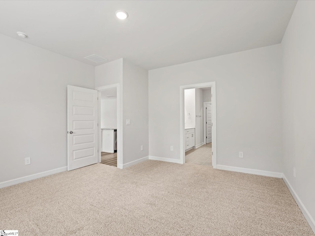217 Merriweather Way, Spartanburg, SC 29302 - unfurnished bedroom featuring light carpet, baseboards, recessed lighting, and ensuite bathroom