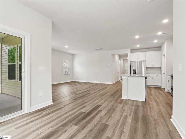 217 Merriweather Way, Spartanburg, SC 29302 - unfurnished living room with plenty of natural light, light wood-style floors, baseboards, and recessed lighting