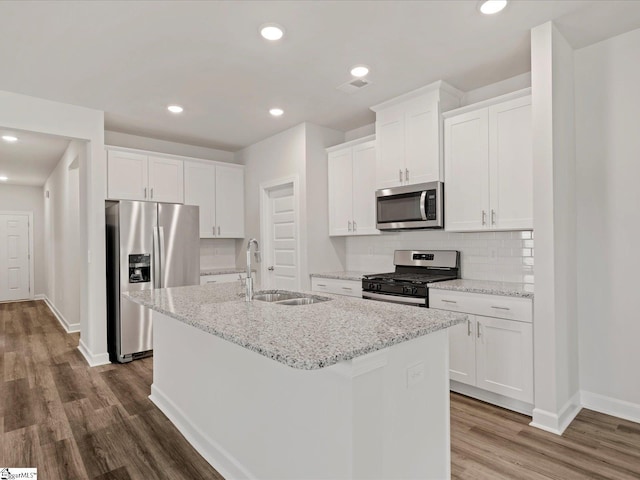 217 Merriweather Way, Spartanburg, SC 29302 - kitchen with stainless steel appliances, a sink, an island with sink, dark wood-style flooring, and baseboards