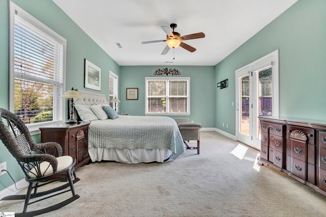 bedroom featuring a ceiling fan, access to outside, carpet flooring, and multiple windows