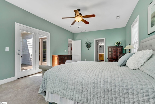 carpeted bedroom with baseboards, multiple windows, access to exterior, and visible vents