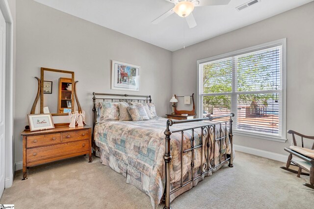 bedroom with visible vents, baseboards, multiple windows, and carpet flooring