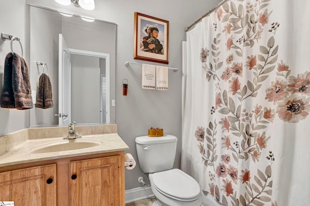 bathroom with toilet, curtained shower, and vanity