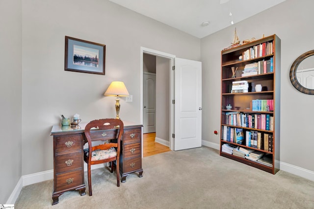 home office with baseboards and carpet
