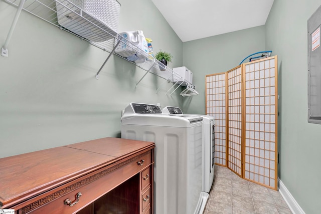 laundry room with baseboards, light tile patterned floors, laundry area, and washing machine and clothes dryer