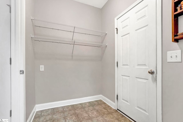 clothes washing area with baseboards