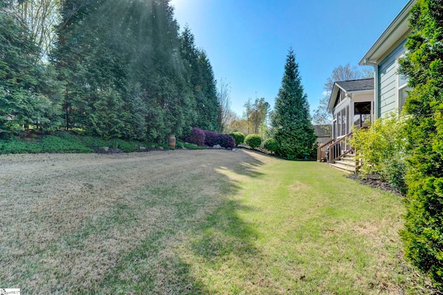 view of yard featuring a sunroom