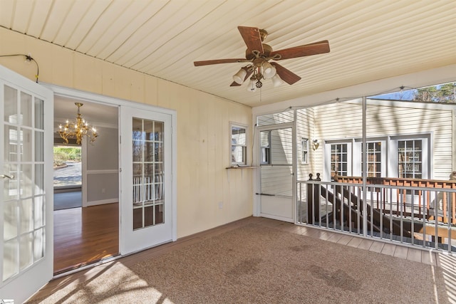 unfurnished sunroom with a notable chandelier and french doors