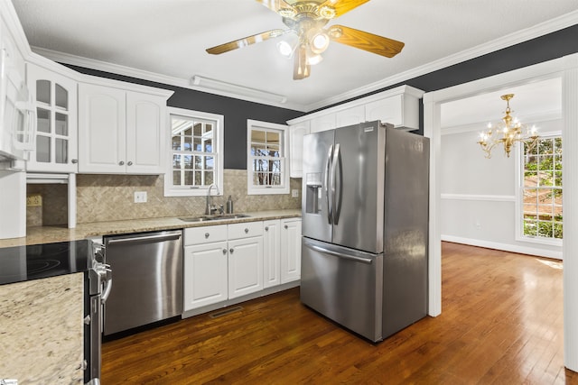 kitchen featuring stainless steel appliances, white cabinetry, a sink, and crown molding
