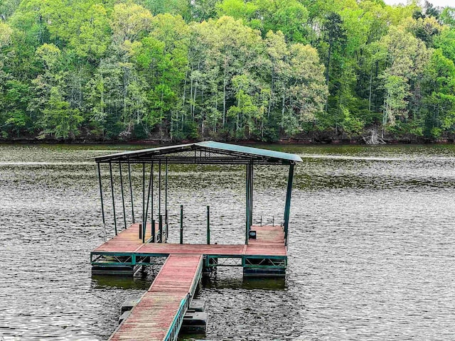 view of dock featuring a view of trees and a water view
