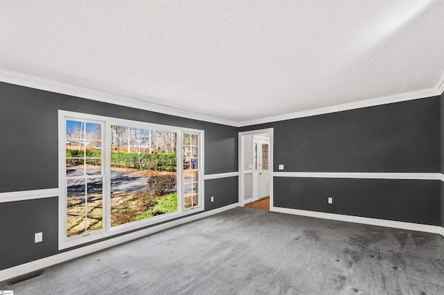 spare room featuring baseboards, carpet flooring, a textured ceiling, and crown molding