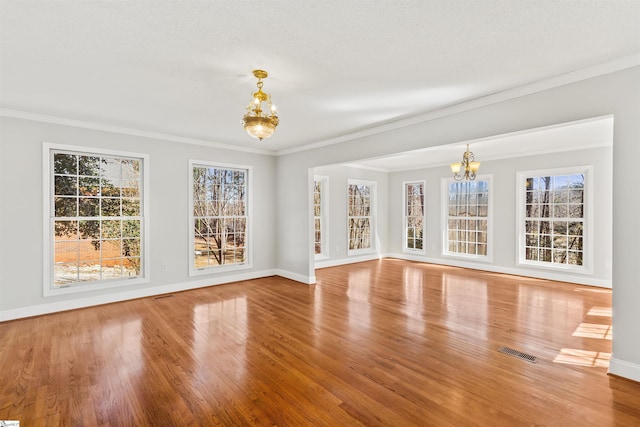 interior space with visible vents, an inviting chandelier, and wood finished floors