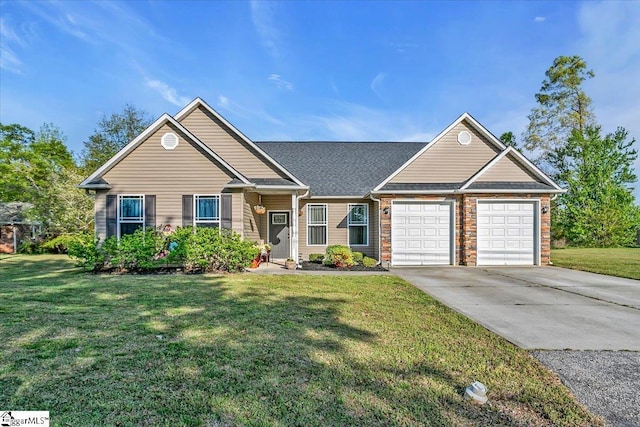 view of front of house featuring driveway, a shingled roof, a garage, and a front lawn