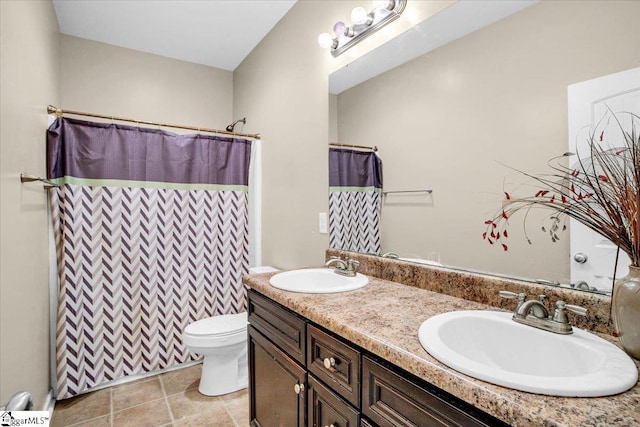 full bath with double vanity, curtained shower, a sink, and toilet